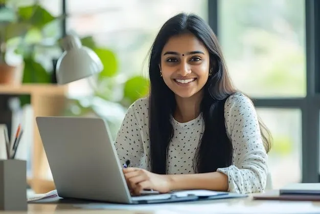 Smiling woman working on a laptop at a desk