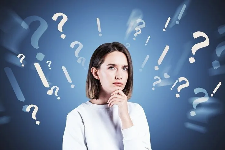 Woman thinking, surrounded by question marks on blue background.